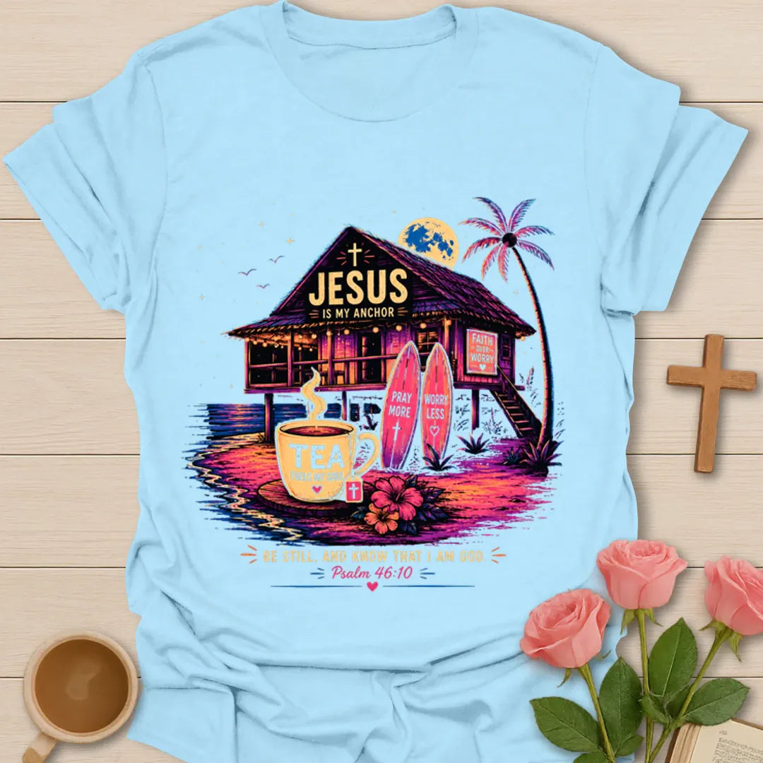 Jesus Is My Anchor tea shirt with beach hut, surfboards, palm tree, moon, teacup, and Psalm 46:10 text. - Light Blue