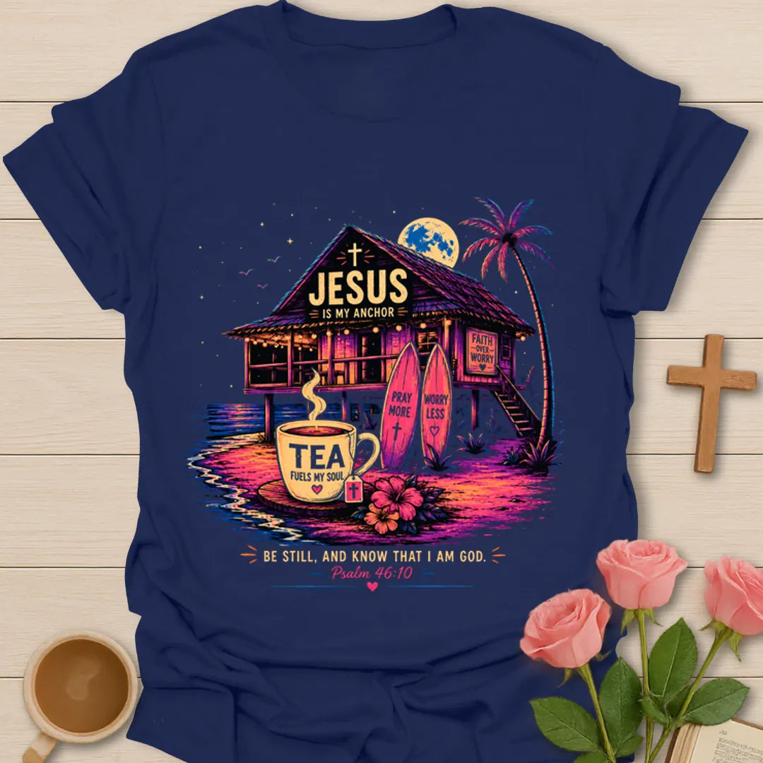 Jesus Is My Anchor tea shirt with beach hut, surfboards, palm tree, moon, teacup, and Psalm 46:10 text. - Navy