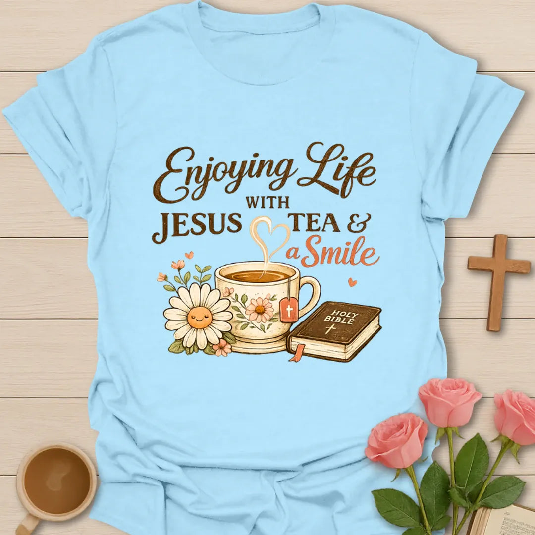 Enjoying Life With Jesus Tea and a Smile shirt with teacup, Bible, flowers, and heart-shaped steam. - Light Blue