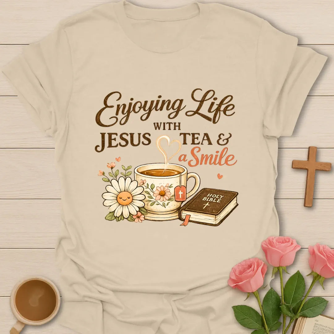 Enjoying Life With Jesus Tea and a Smile shirt with teacup, Bible, flowers, and heart-shaped steam. - Sand