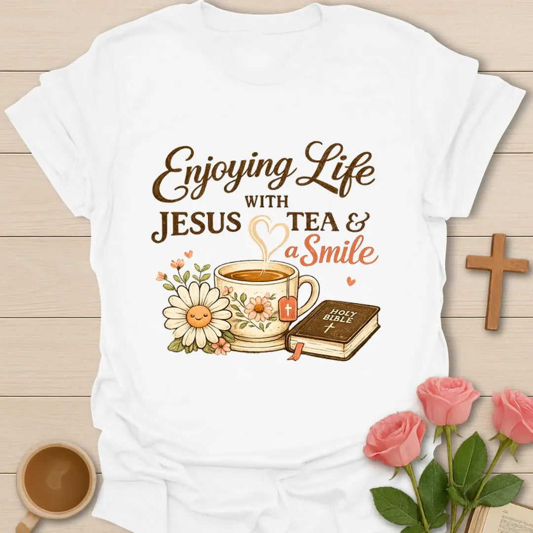 Enjoying Life With Jesus Tea and a Smile shirt with teacup, Bible, flowers, and heart-shaped steam. - White