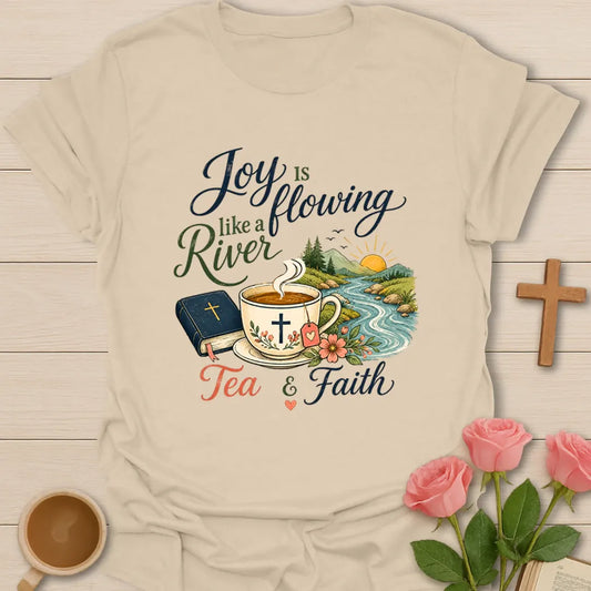 Joy Is Flowing Like A River shirt with teacup, Bible, river, mountains, sunrise, flowers, and tea faith text. - Sand