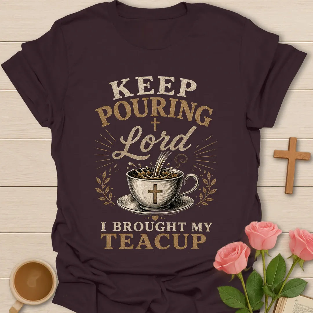 Keep Pouring Lord, I Brought My Teacup t-shirt with vintage lettering and tea pouring into a cross-marked teacup. - Dark Chocolate