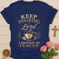 Keep Pouring Lord, I Brought My Teacup t-shirt with vintage lettering and tea pouring into a cross-marked teacup. - Navy