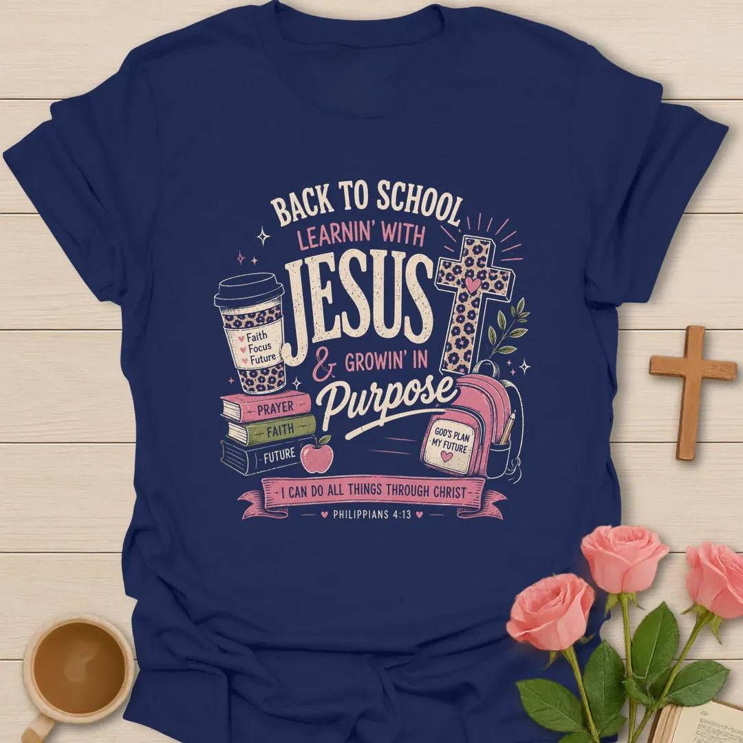 Learning With Jesus back to school shirt with books, backpack, cross, coffee cup, apple, and Philippians 4:13 text. - Navy