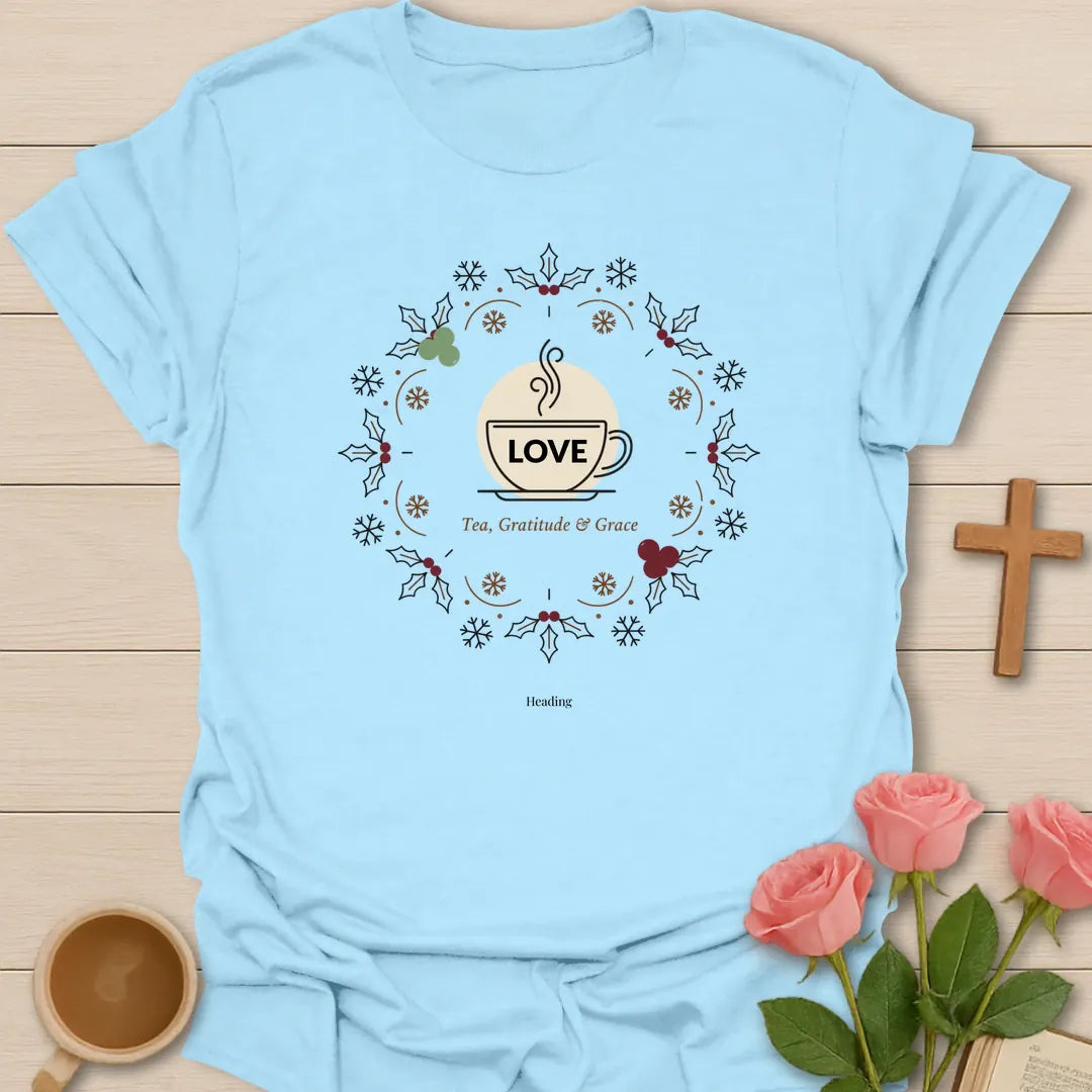 Love Tea Gratitude and Grace shirt with teacup, wreath, holly, berries, snowflakes, and warm vintage accents. - Light Blue