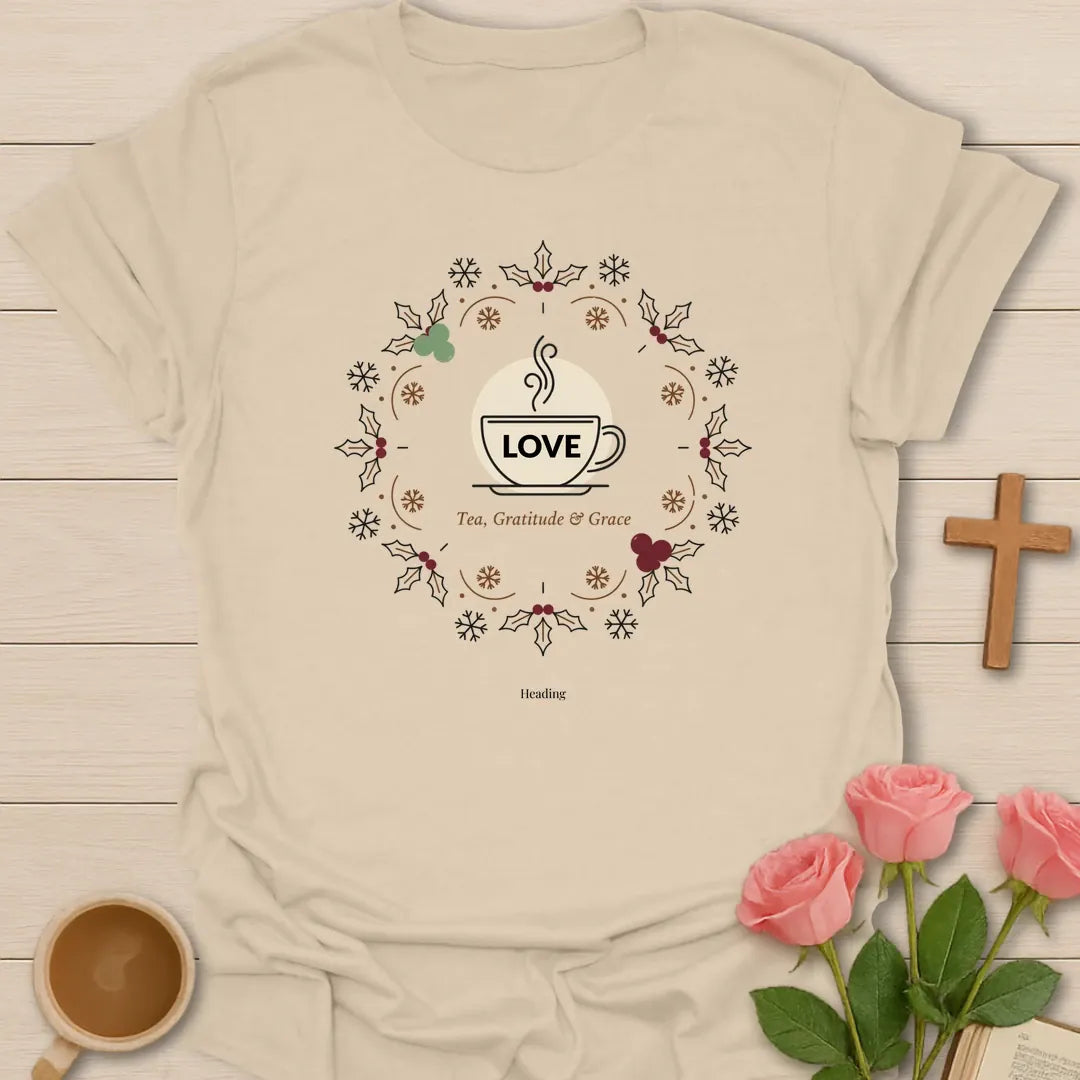 Love Tea Gratitude and Grace shirt with teacup, wreath, holly, berries, snowflakes, and warm vintage accents. - Sand