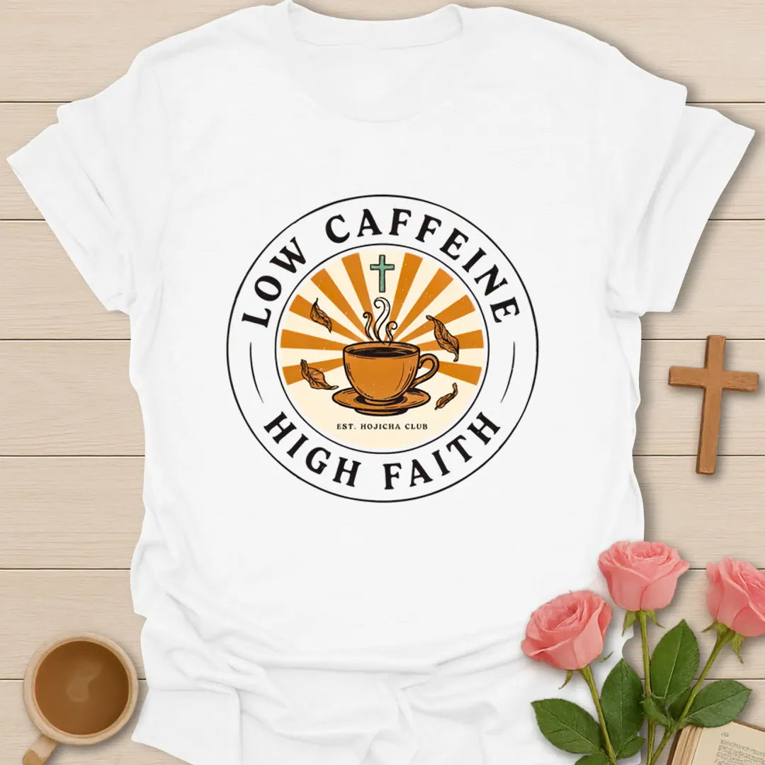 Low Caffeine High Faith shirt with Hojicha tea cup, sunburst, cross, falling leaves, and circular badge design. - White