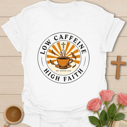 Low Caffeine High Faith shirt with Hojicha tea cup, sunburst, cross, falling leaves, and circular badge design. - White