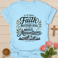 Mustard Seed Faith shirt with mountain scene, mustard flowers, faith lettering, and Matthew 17:20 verse. - Light Blue