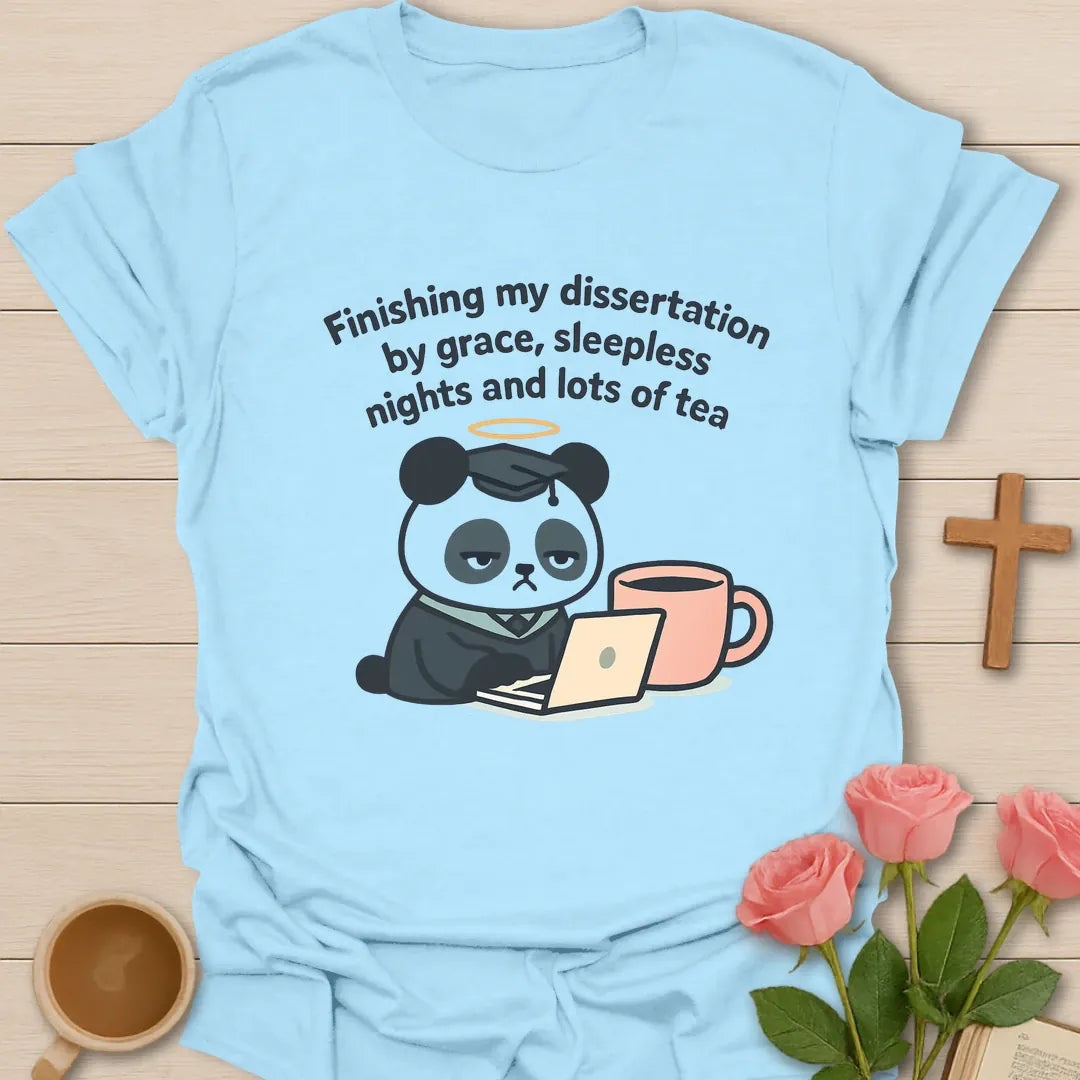 Dissertation grace tea shirt with tired panda wearing graduation cap, laptop, peach tea mug, halo, and curved lettering. - Light Blue
