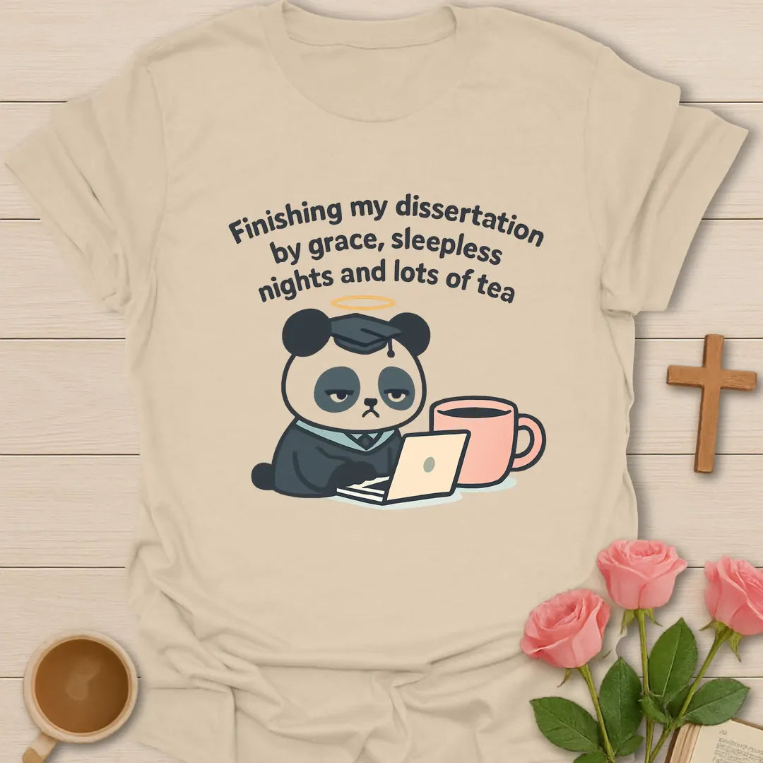 Dissertation grace tea shirt with tired panda wearing graduation cap, laptop, peach tea mug, halo, and curved lettering. - Sand