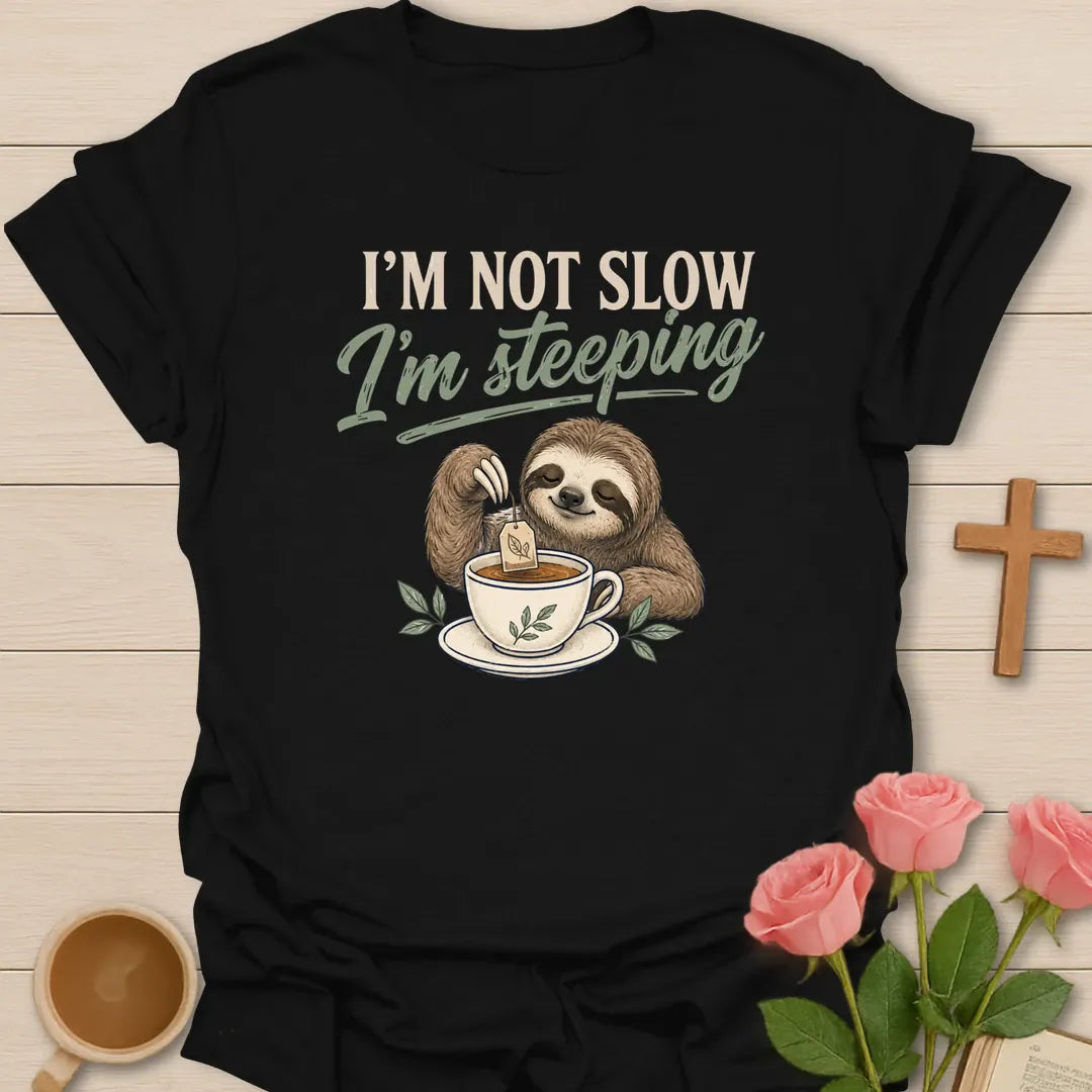 Not Slow Steeping Sloth shirt with cute sloth, teacup, and playful cream lettering. - Black