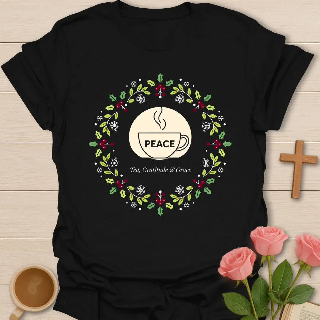 Peace Tea Gratitude and Grace shirt with teacup, wreath, holly berries, snowflakes, and peaceful Christmas design. - Black