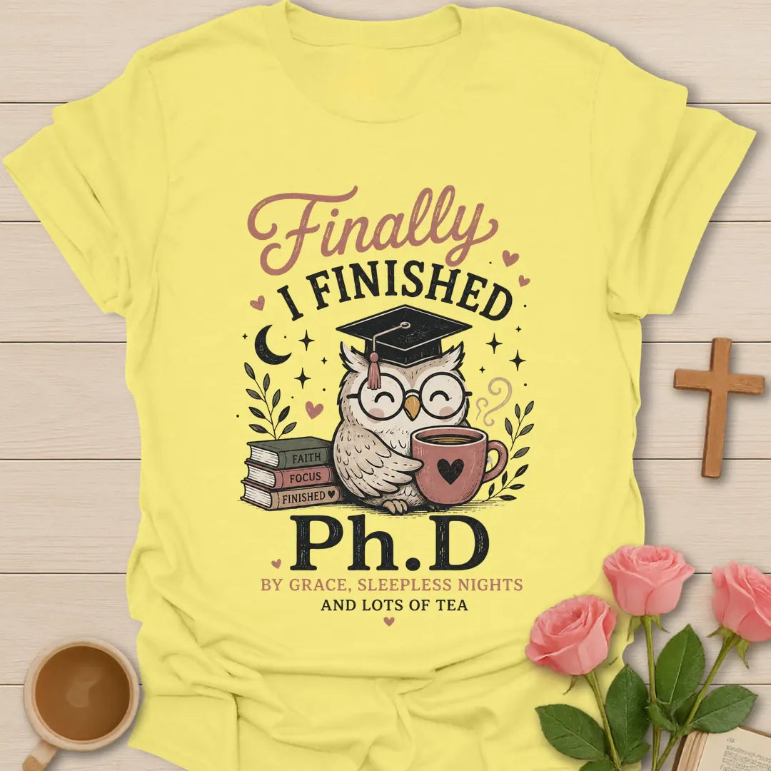 Ph.D and Lots of Tea shirt with graduation cap, teacup, and faith-inspired typography. - Cornsilk