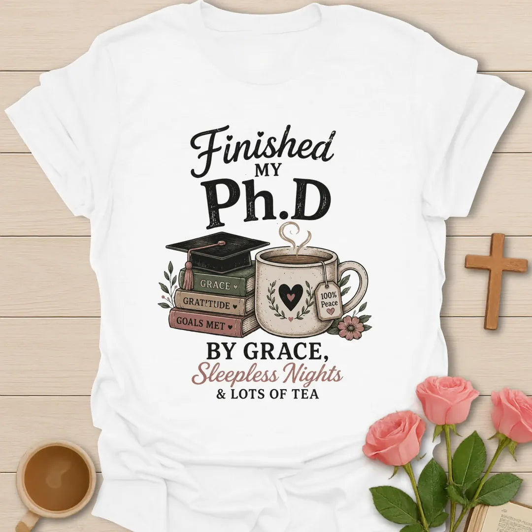 Ph.D Finished graduation shirt with graduation cap, faith message, and 2 Timothy 4:7 text. - White