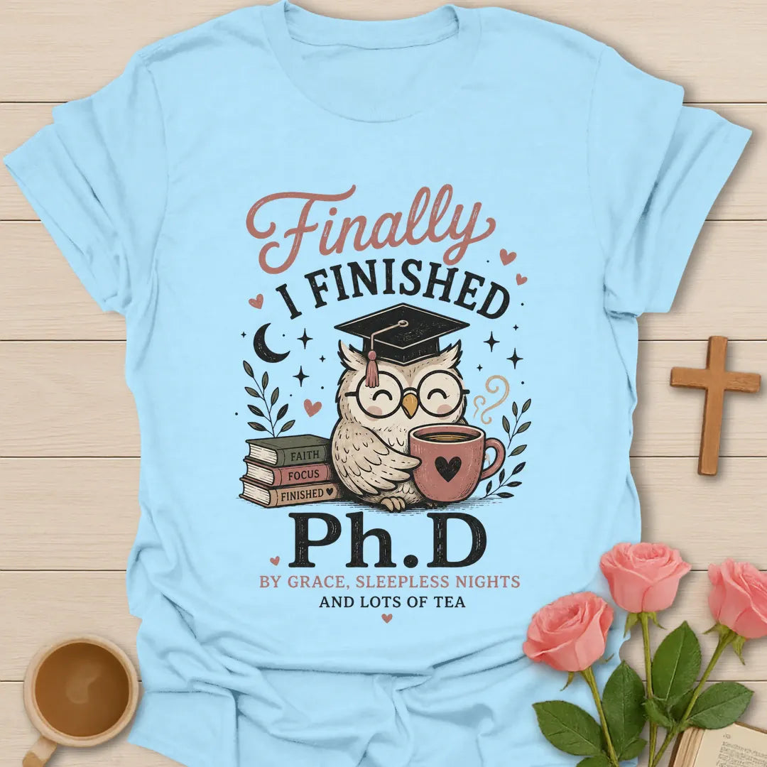 Ph.D and Lots of Tea shirt with graduation cap, teacup, and faith-inspired typography. - Light Blue
