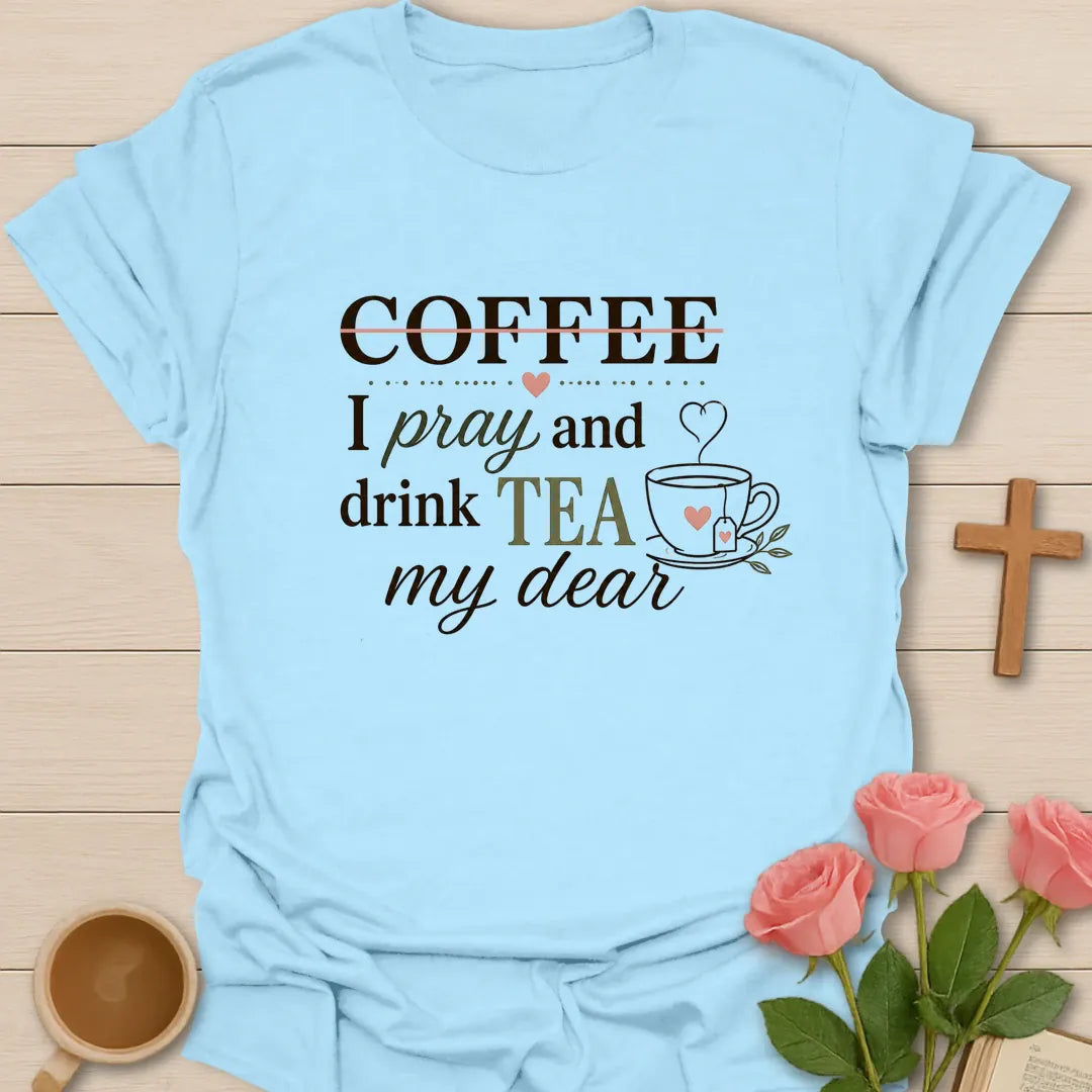 Pray and Drink Tea shirt with teacup, praying hands, and cream vintage lettering. - Light Blue