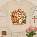 Pumpkin Tea Season t-shirt with cozy fall pumpkin and tea artwork and faith-inspired design - Sand