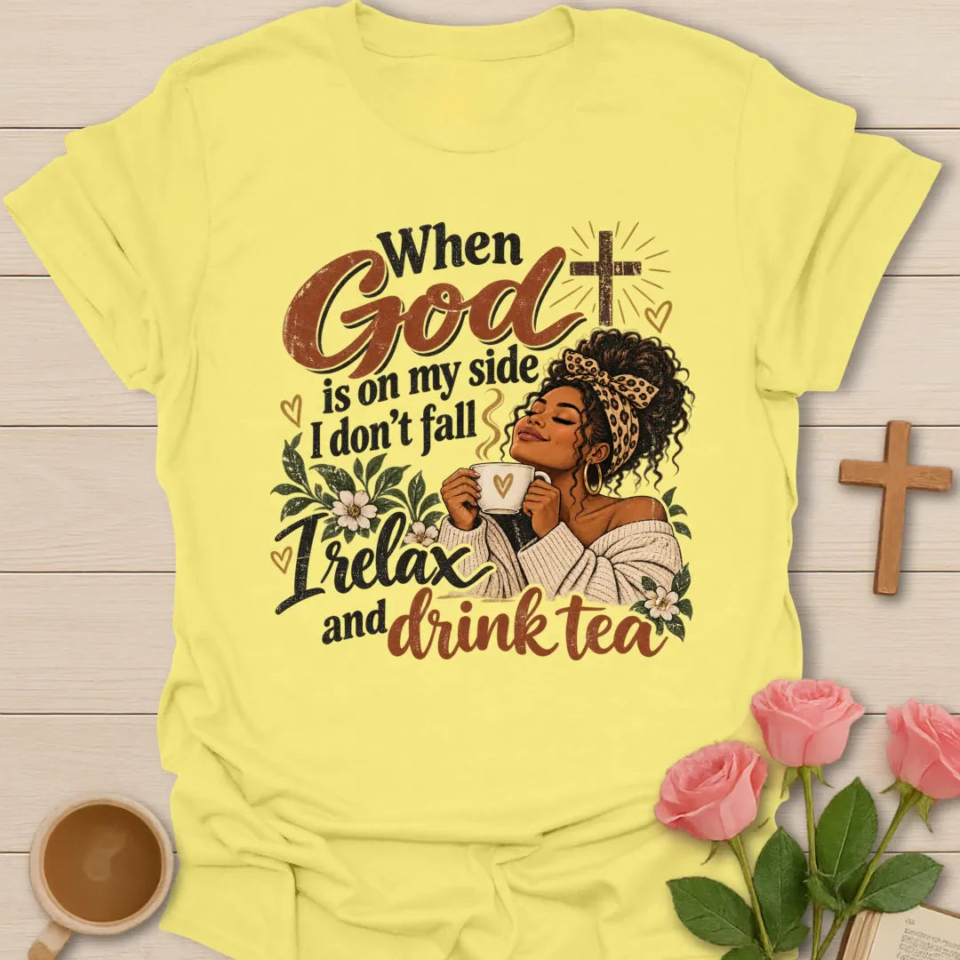 When God Is On My Side I Don't Fall, I Relax And Drink Tea Christian t-shirt with a woman in a leopard headband holding a teacup beside a glowing cross - Cornsilk