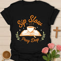 Sip Slow Pray Deep Christian tea shirt with steaming teacup, open Bible, stars, and leafy accents. - Black