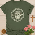 Sippin Decaf and Standin Faithful shirt with mason jar iced tea, cross charm, circular badge, and cream lettering. - Military Green