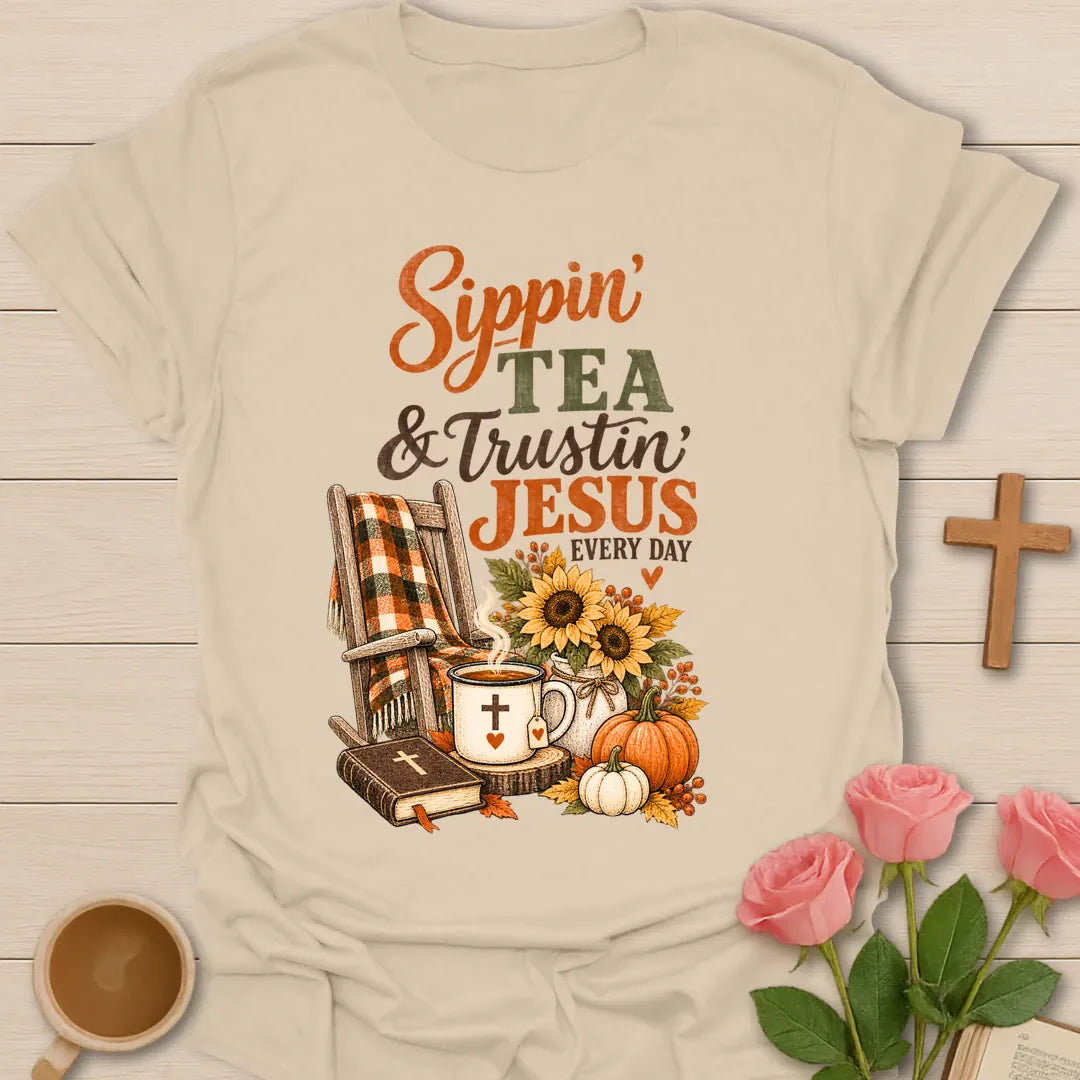 Sippin and Trustin shirt with cozy lettering and a faith-inspired fall tea design. - Sand