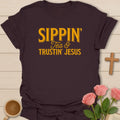 Sippin and Trustin Jesus shirt with cream vintage lettering and simple stacked tea faith typography. - Dark Chocolate