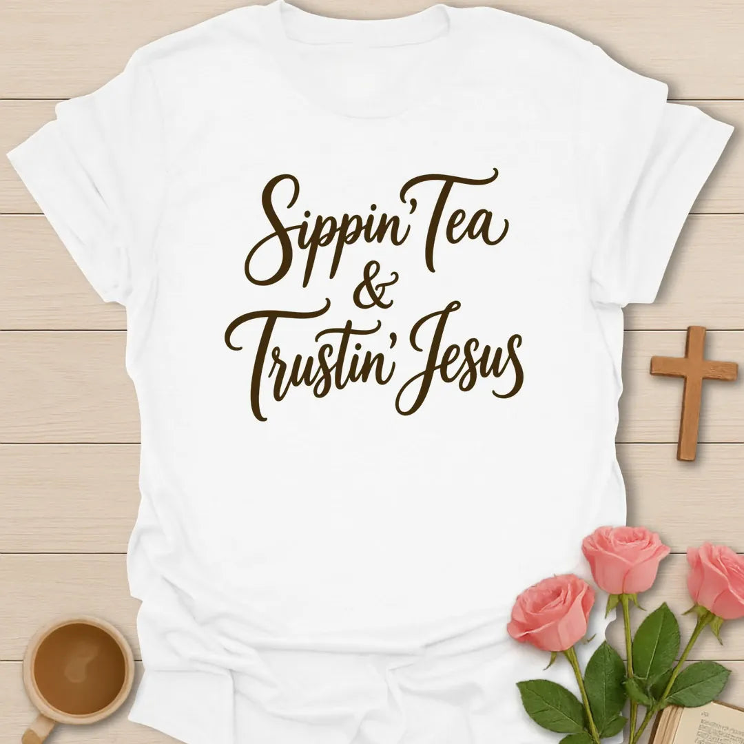 Sippin and Trustin Jesus shirt with teacup, cross, and cream vintage lettering. - White