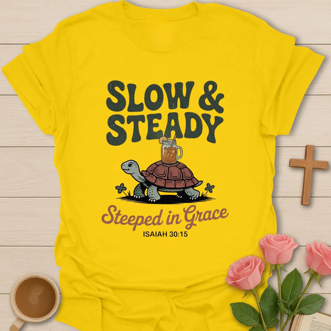 Slow & Steady Steeped in Grace Christian t-shirt with a smiling tortoise carrying a mason jar of iced tea and Isaiah 30:15 - Daisy