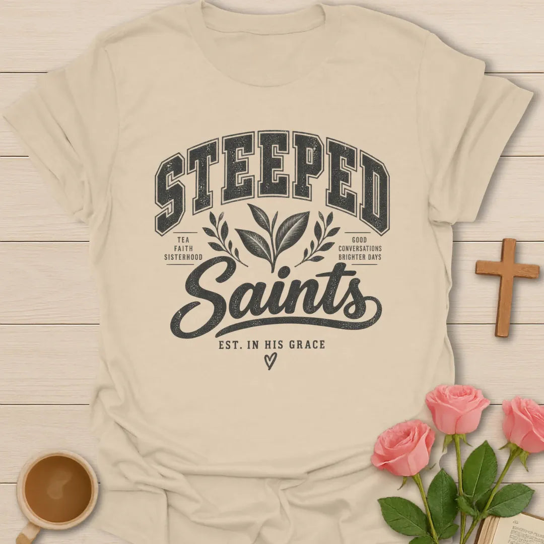 Steeped Saints T-Shirt with tea-inspired lettering and faith design. - Sand