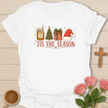 Sweet Tea Tis The Season shirt with mason jar sweet tea, Christmas tree, gift box, Santa hat, stars, and red lettering. - White