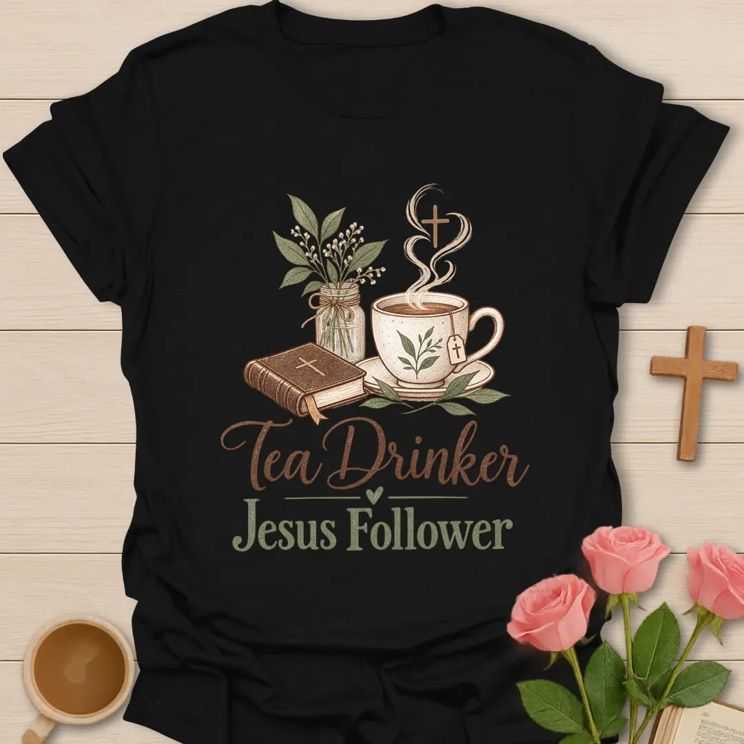 Tea Drinker Jesus Follower t-shirt with script lettering, a Bible, a teacup with cross-shaped steam and a jar of greenery. - Black