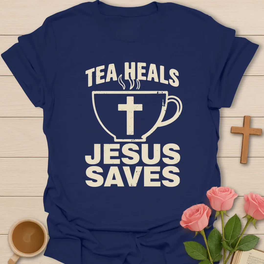 Tea Heals Jesus Saves shirt with bold cream lettering, teacup with cross, and distressed vintage texture. - Navy