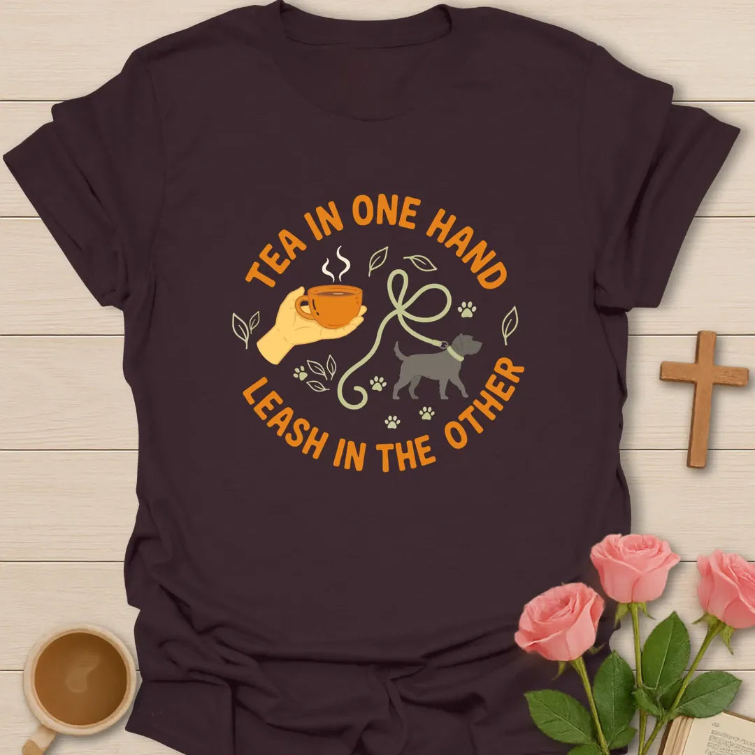 Tea in One Hand Leash in the Other Christian t-shirt with a hand holding a teacup, a dog on a leash and paw prints in a circle - Dark Chocolate