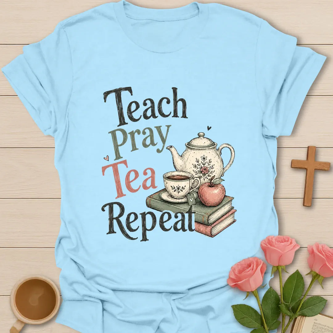 Teach Pray Tea Repeat shirt with stacked red and green lettering, green teapot silhouette, red apple, stars, and vintage distressed texture. - Light Blue