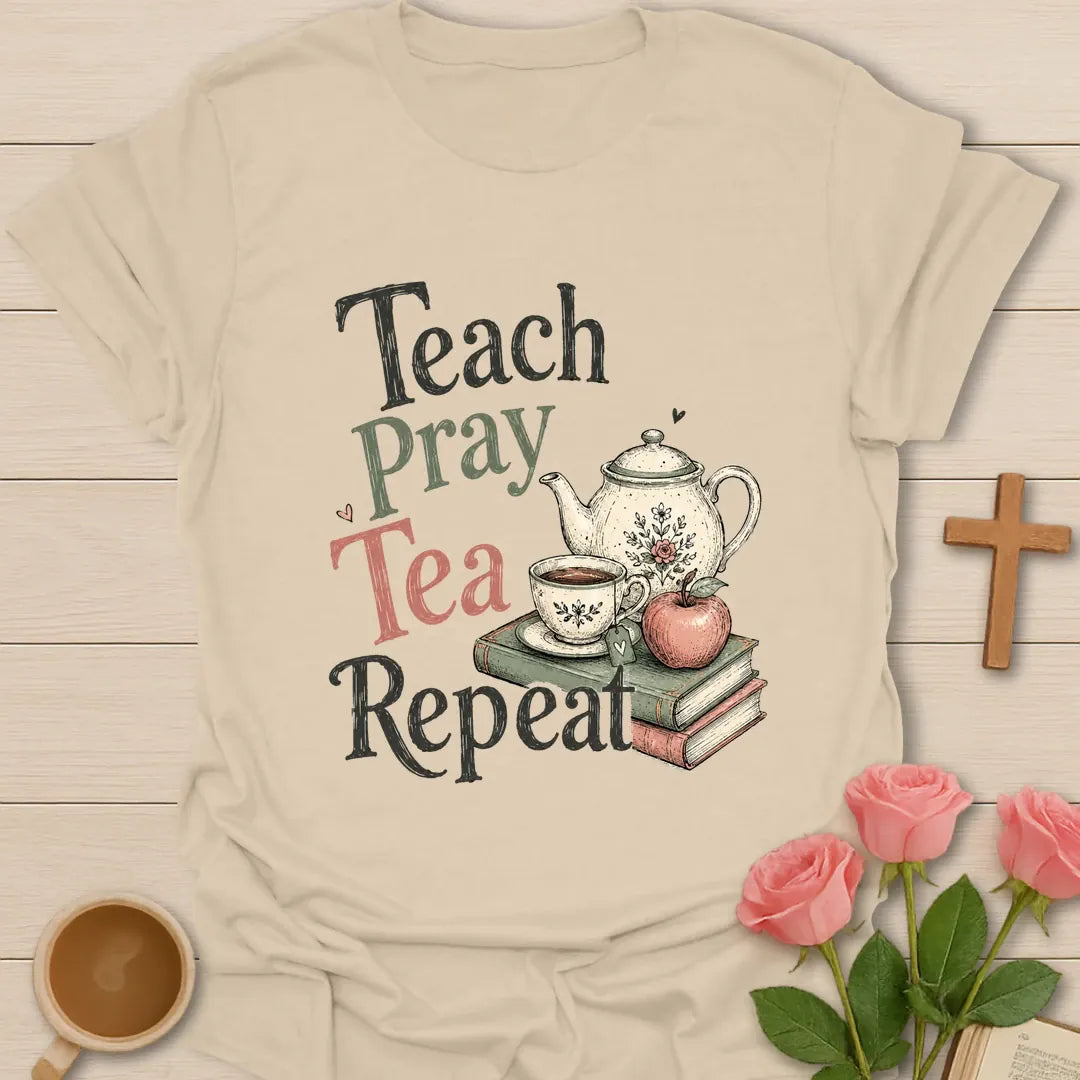 Teach Pray Tea Repeat shirt with stacked red and green lettering, green teapot silhouette, red apple, stars, and vintage distressed texture. - Sand