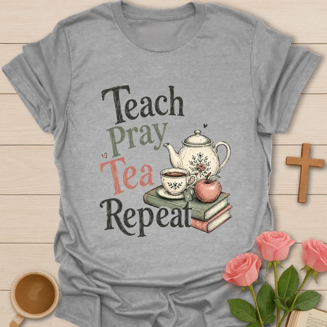 Teach Pray Tea Repeat shirt with stacked red and green lettering, green teapot silhouette, red apple, stars, and vintage distressed texture. - Sport Grey
