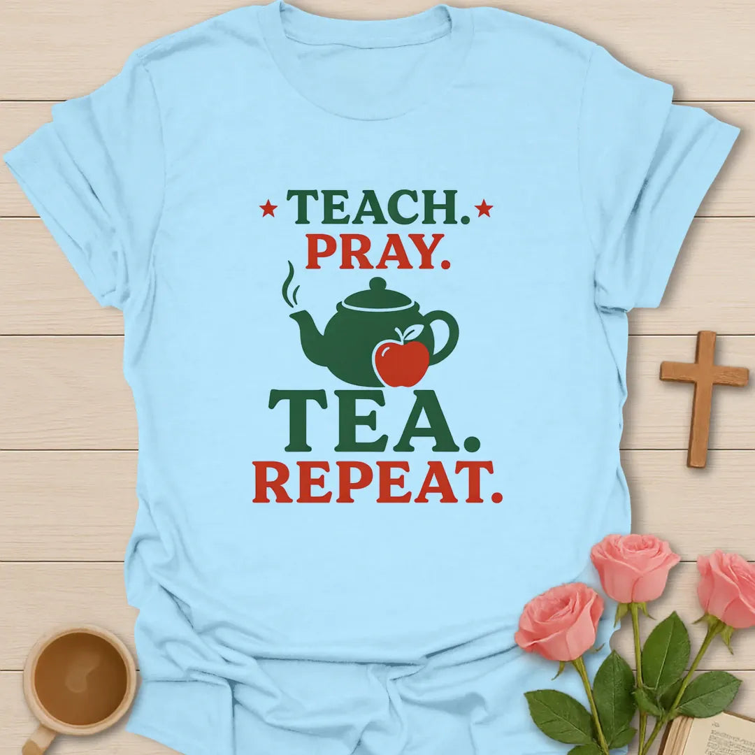 Teach Pray Tea Repeat shirt with stacked red and green lettering, green teapot silhouette, red apple, stars, and vintage distressed texture. - Light Blue