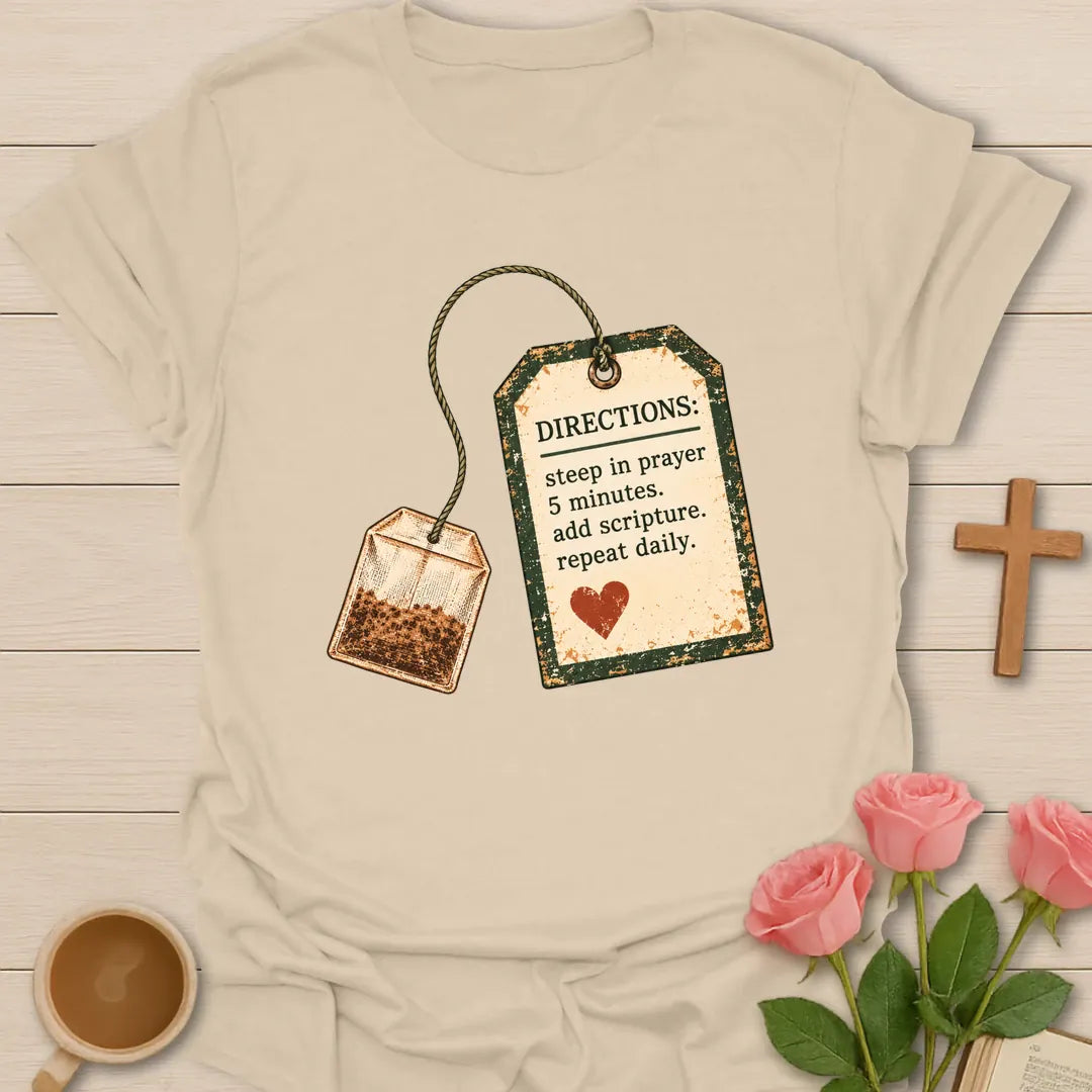 Christian t-shirt with a vintage tea bag and tag reading Directions: steep in prayer 5 minutes, add scripture, repeat daily - Sand