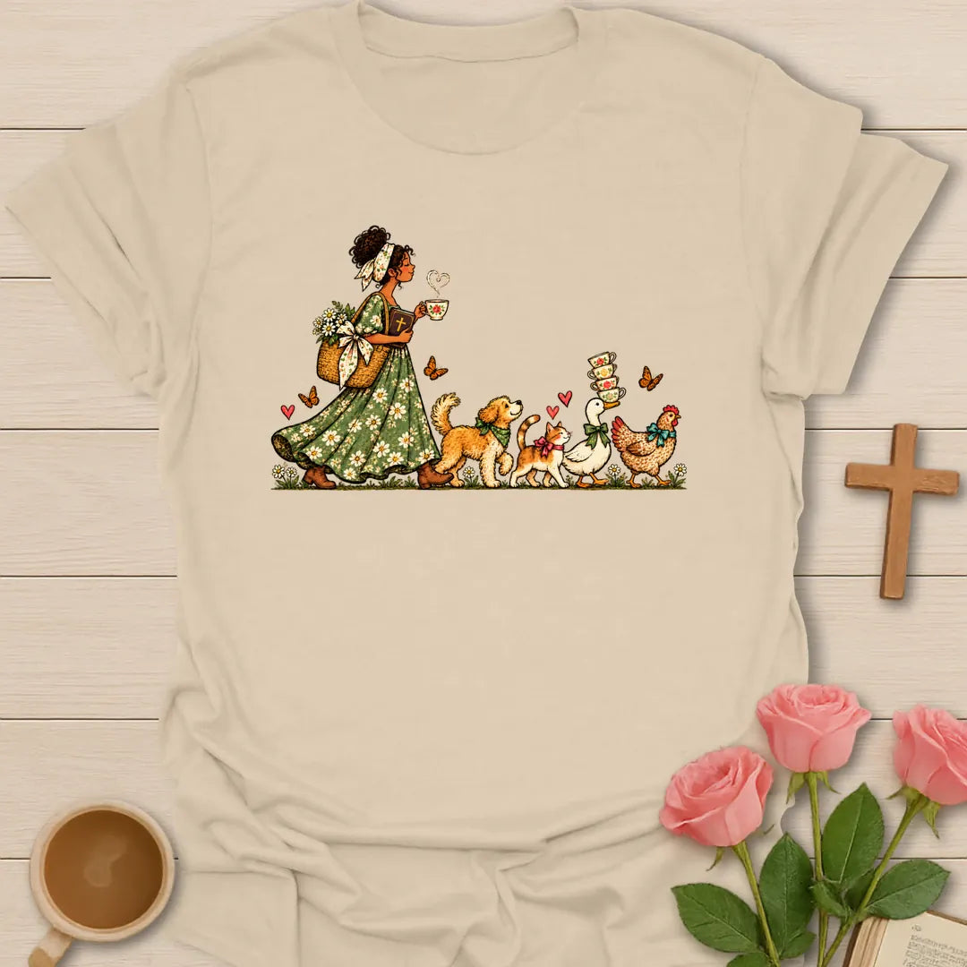 Tea-Time Parade t-shirt with a woman in a floral dress holding a teacup, followed by a dog, a cat, a goose and a chicken carrying teacups - Sand