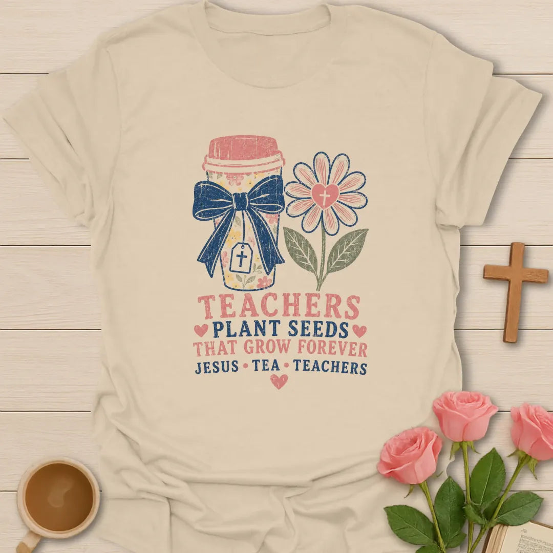 Teachers Plant Seeds shirt with floral pencil jar, navy bow, pink flower with cross, stacked text, hearts, and Jesus Tea Teachers phrase. - Sand