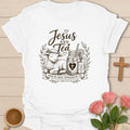 White The Lamb Jesus and Tea shirt with lamb, mason jar iced tea, cross heart, leaves, ribbon, and John 10:11 text. 