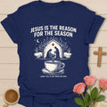Jesus is the Reason for the Season shirt with nativity scene, steaming teacup, stars, and Christmas faith text. - Navy