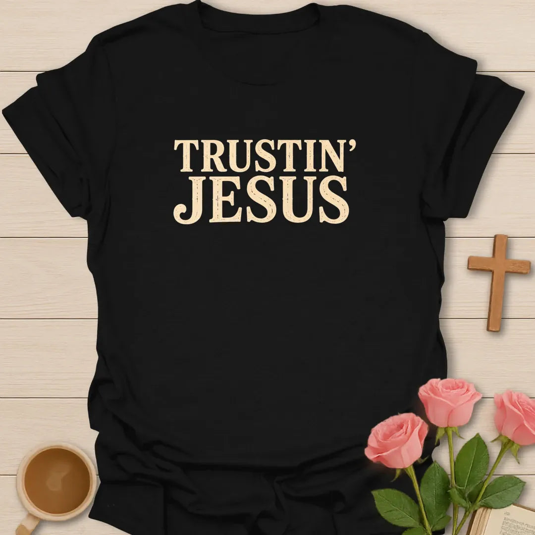 Trustin Jesus shirt with large cream vintage block lettering and distressed texture. - Black