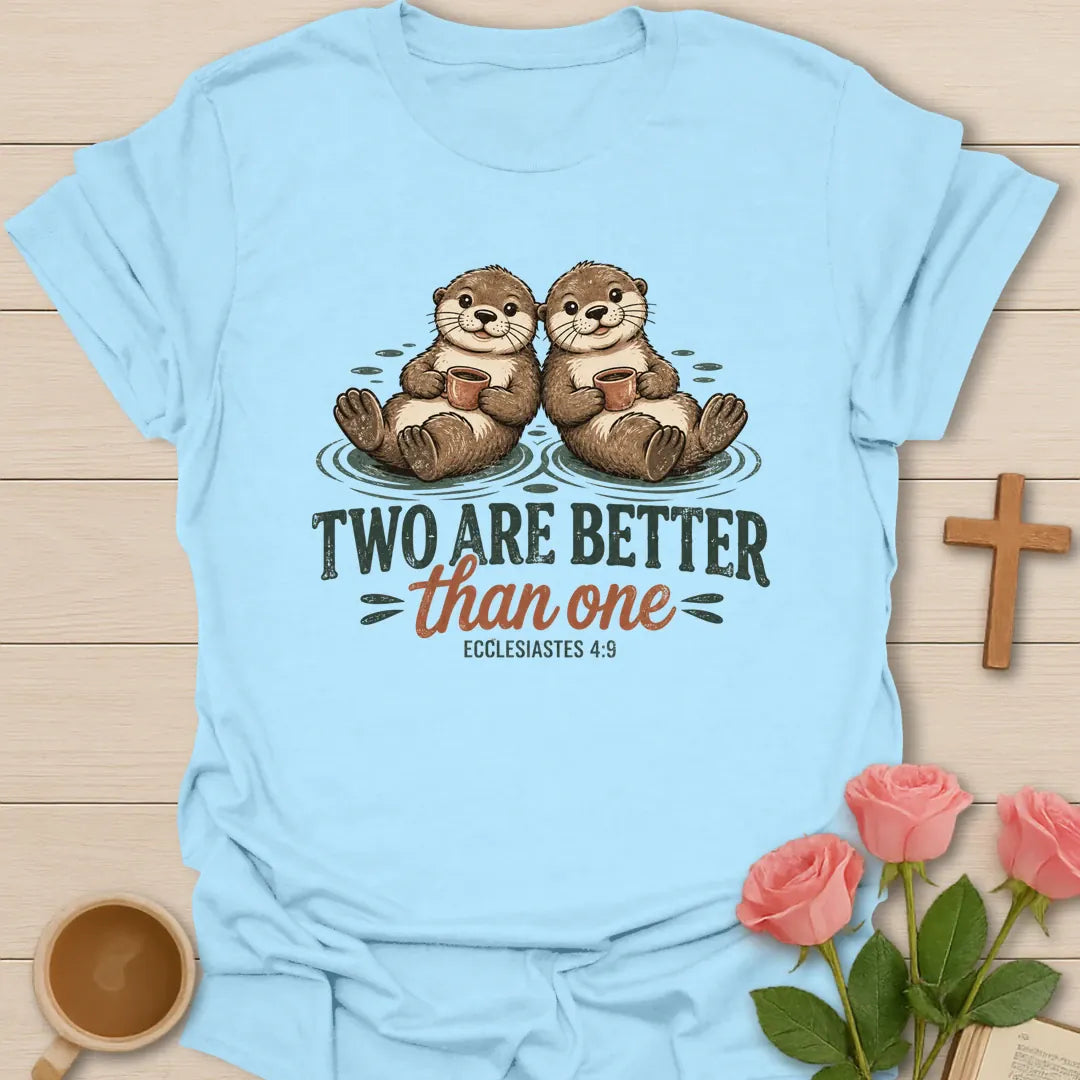 Two Are Better Than One Christian t-shirt with two smiling otters floating side by side holding mugs and Ecclesiastes 4:9 - Light Blue