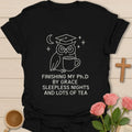 Wise owl dissertation shirt with white line art owl in graduation cap holding mug, moon, stars, and stacked PhD by grace text. - Black